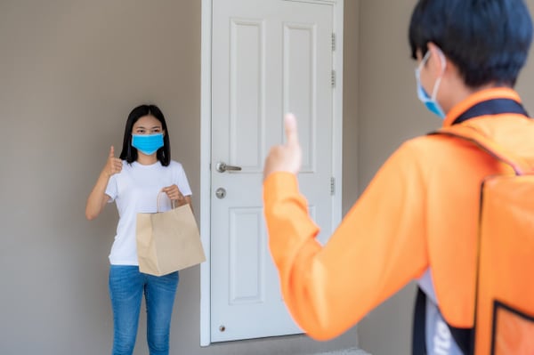 asian-woman-pick-up-delivery-food-bag-from-door-knob-thumb-up-form-contactless-contact-free-from-delivery-rider-with-bicycle-front-house-social-distancing-infection-risk-coronavirus-concept_73503-1925