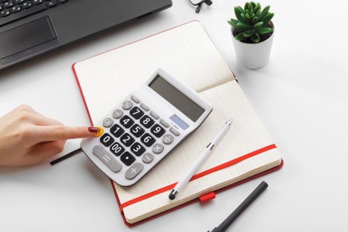 business-woman-working-with-financial-data-hand-using-calculator_127657-7812