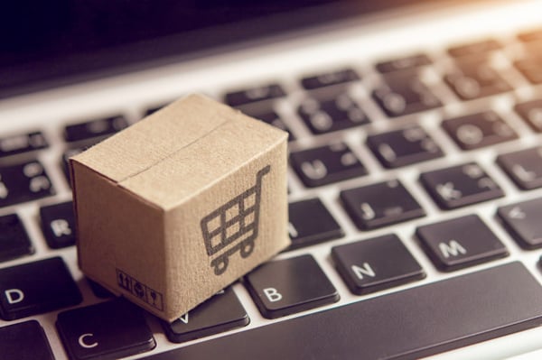 online-shopping-paper-cartons-parcel-with-shopping-cart-logo-laptop-keyboard_9635-3291