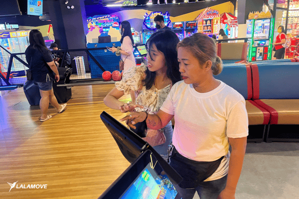 Female Lalamove driver plays with her daughter at Timezone