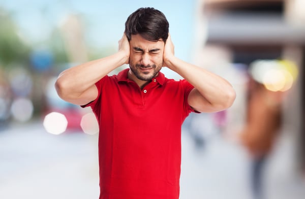 a man covering his ear