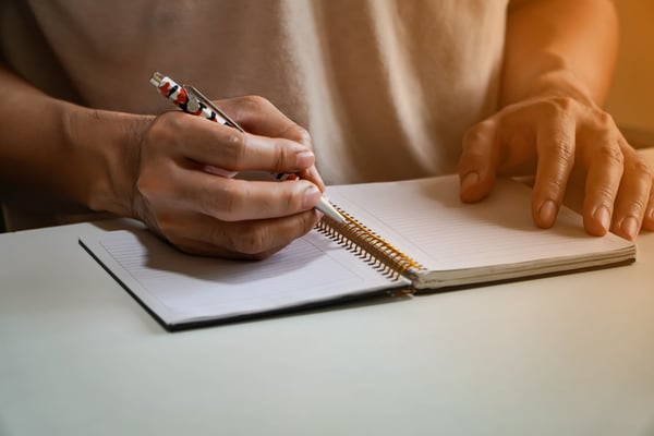 a man writing on a paper