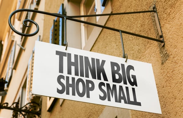 a shop sign written think big shop small