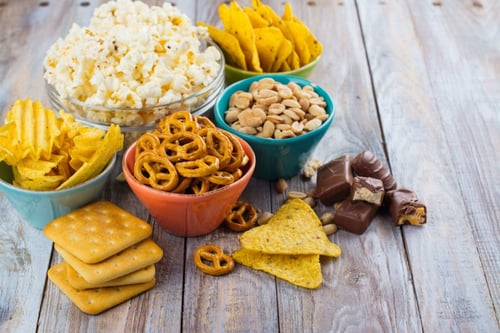 an image of finger foods and snacks such as pretzels, crackers, chocolates and popcorns