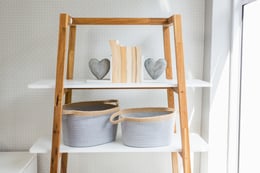 books-heart-shape-basket-arranged-shelf-living-room
