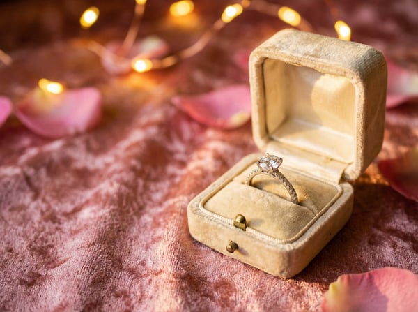 engagement ring on a velvety table