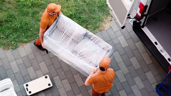 lalamove drivers loading a sofa to a lorry