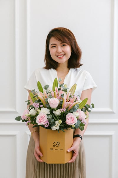 penny choo the co-founder of bloomthis holding a bouquet of flower