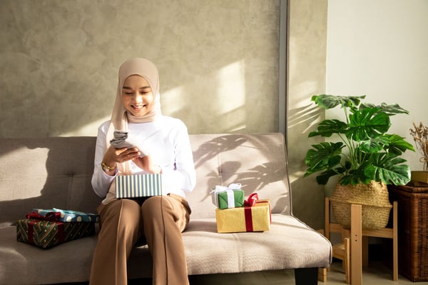 seorang wanita sedang shopping online untuk hari raya