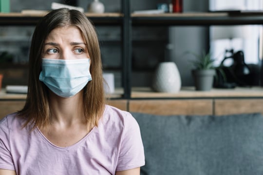 sick-woman-wearing-protective-mask-home_23-2147953259