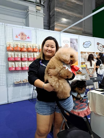 yen nee from furry times holding her dog at the pet expo