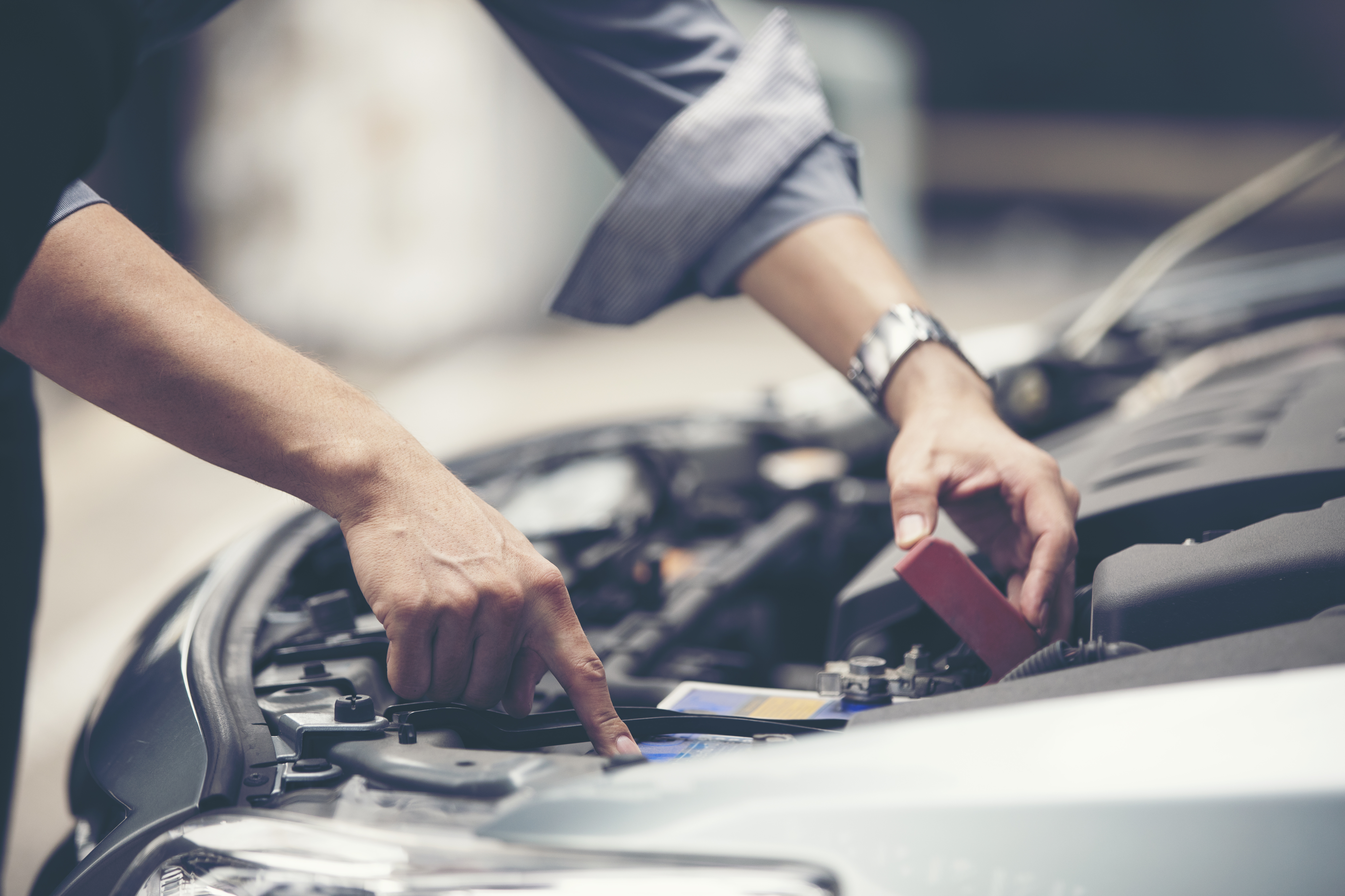 vecteezy_man-checking-the-engine-of-a-car_3462127